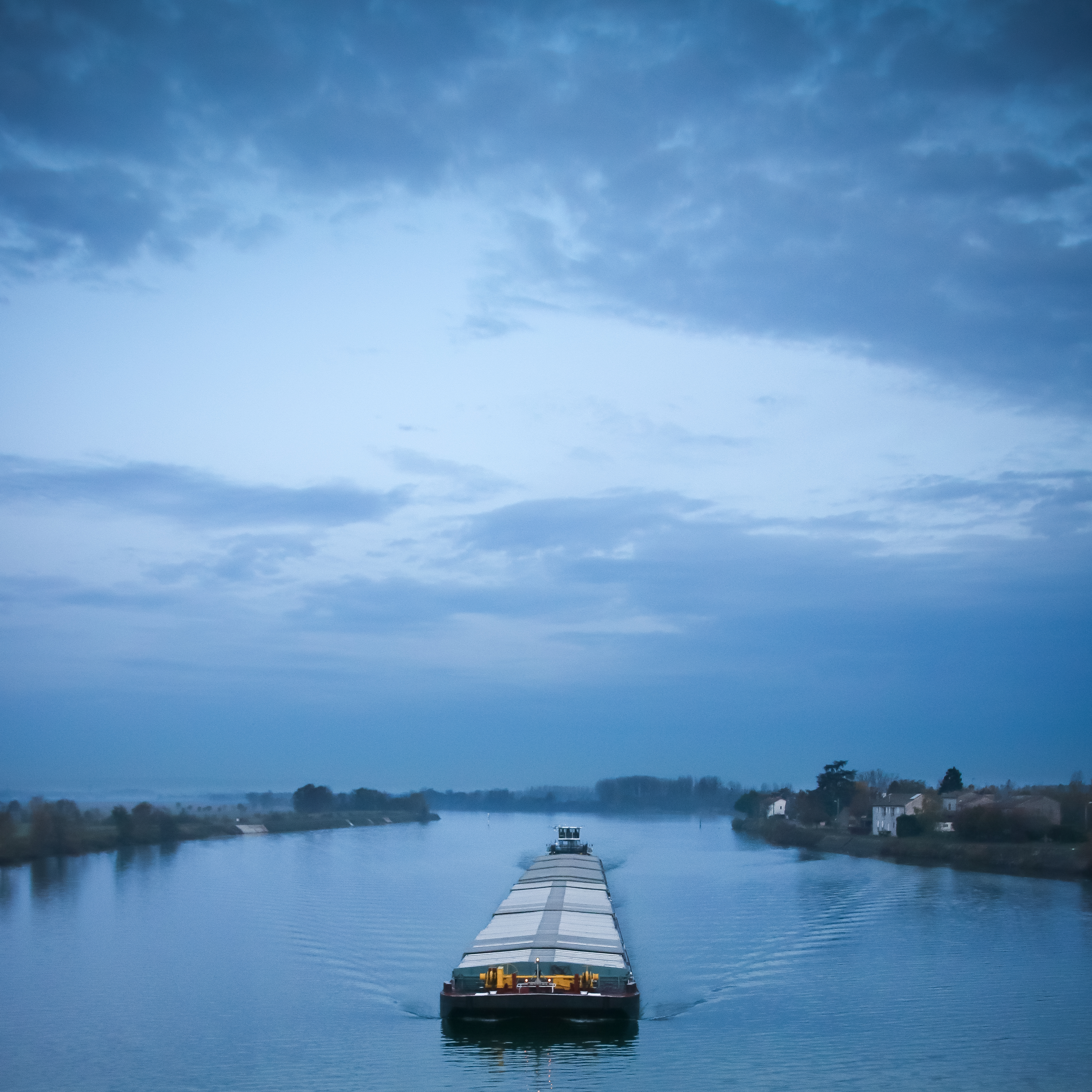 sailboat-sailing-river-against-sky